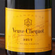 Bottle of Veuve Clicquot Brut champagne. The label features a yellow background with the brand name, logo, and details about its origin in Reims, France. Bottle of Veuve Clicquot Brut champagne. The label features a yellow background with the brand name, logo, and details about its origin in Reims, France.